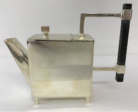 A silver plated Christopher Dresser style teapot of Art Deco design. Of square form, raised on 4 square legs and with wooden 