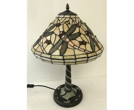 A tiffany style table lamp with leaded glass shade and lamp base. Dragonfly detail to shade and base. Approx. 58cm tall.