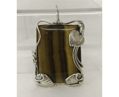 A large rectangular shaped Tiger's eye pendant framed in an Art Nouveau style 925 silver mount.  Approx. 6cm tall (with bale)