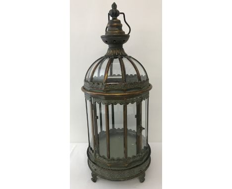 A large copper ornamental free standing lantern with glass panels and hanging hook. Front opening, hinged door. Approx. 60cm 