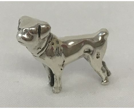 A miniature 925 silver figure of a dog.  Approx. 2cm tall x 2.5cm long. Total weight approx. 10.6g.