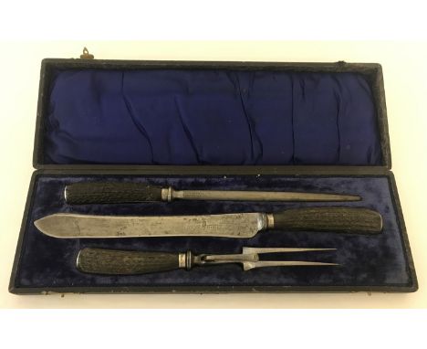 A cased Edwardian 3 piece carving set with faux horn handles and silver mounts. Hallmarked Sheffield 1909. 