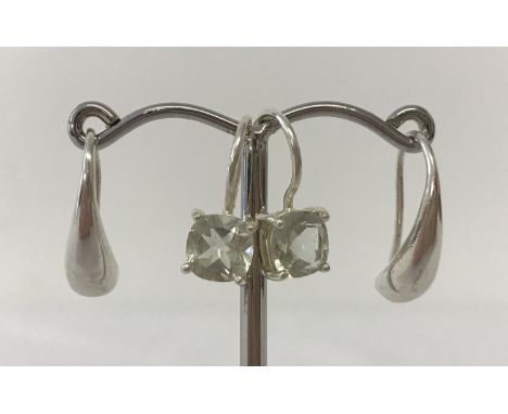2 pairs of modern design silver earrings. A pair of solid teardrop style drops Together with a pair of drops set with pale gr