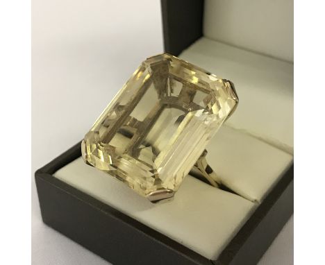 A very large emerald cut Citrine and 9ct gold dress ring. Citrine approx. 12+ ct. Stone surface measures approx. 28 x 24mm wi