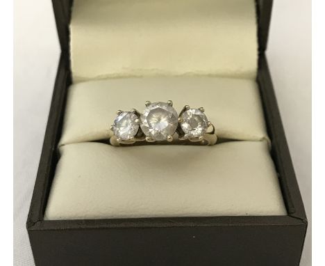 A 9ct gold and clear stone set trilogy ring. Ring size P. Total weight apporx. 1.6g