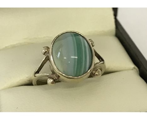 A vintage gold on silver dress ring set with a green banded agate cabochon stone. Ring size N½.  Total weight approx. 3.3g.