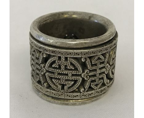 A Chinese white metal Archers ring with central rotating panel decorated with shou characters.  Approx. 3cm diameter.