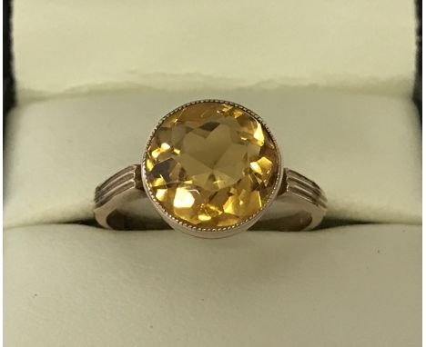 A vintage 9ct gold dress ring set with a large round cut Citrine approx. 4ct. Bezel style setting, ring size N. Total weight 