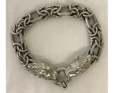 A decorative silver chain bracelet with lion head fixings and round spring clasp. Marked 925 to rear of lion head and spring 