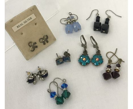 8 pairs of silver and white metal costume jewellery earrings in both stud and drop styles. To include bumble bees costume stu