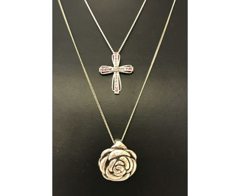 2 silver necklaces. A Silver rose pendant on a 18" fine curb chain. Together with a silver cross pendant set with small pink 