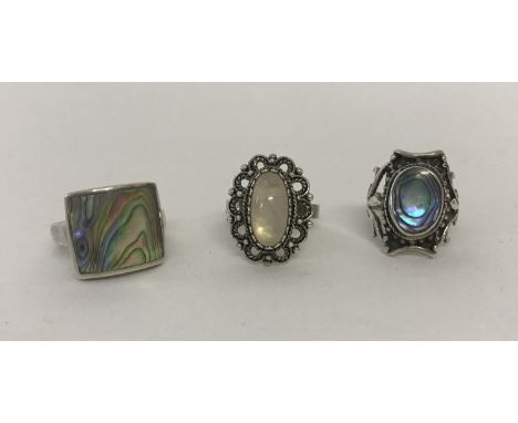 3 modern design silver stone set dress rings. 2 set with abalone shell the other with a rose quartz oval stone. Sizes P, M an