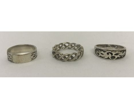 3 men's silver band style rings; 2 with Celtic designs and the other with oriental detail.  Sizes Z, U and Z.