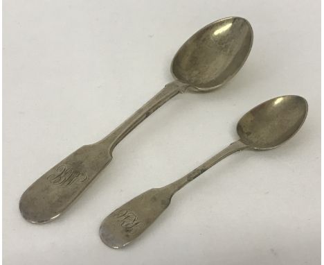 A Victorian silver fiddleback table spoon Hallmarked Thomas Hart Stone, Exeter 1867. Together with a Georgian silver fiddleba