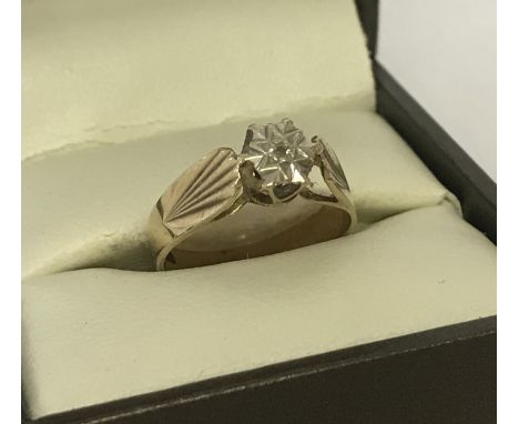 A vintage 9ct gold, illusion set diamond dress ring. Pattern to both shoulders. Single small diamond set to centre of illusio