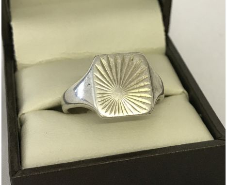 A men's square shaped signet ring with sunray design to top. Size V.  Total weight approx. 5.6g.