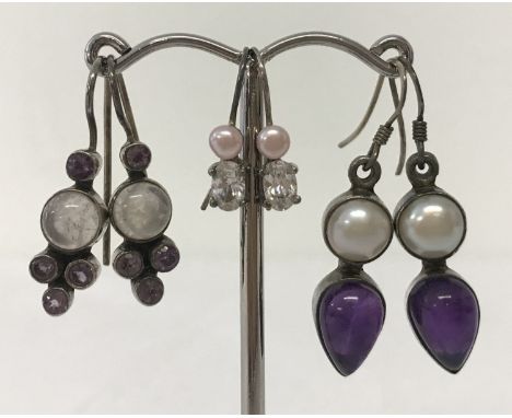 3 pairs of silver earrings set with semi precious stones. All in drop style. Comprising: round freshwater pearls with teardro