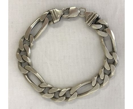 A heavy silver figaro style chain bracelet with lobster style clasp. Total length approx. 8.5 inches. Total weight approx. 53
