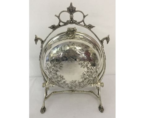 A silver plated folding muffin dish, in the style of a Victorian 2 sectional dish. With ornamental handle and stand and pierc