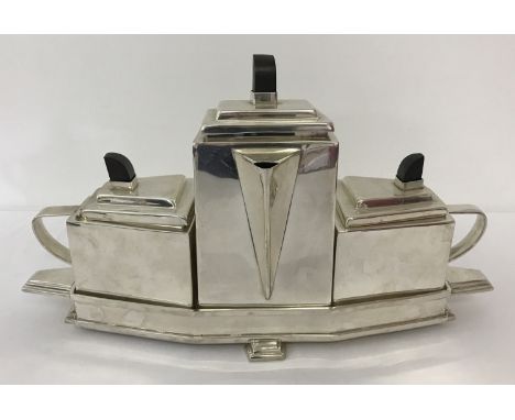 An Art Deco style 4 piece silver plated tea set. Comprising: teapot, milk jug and sugar bowl with wooden finials to lids, in 