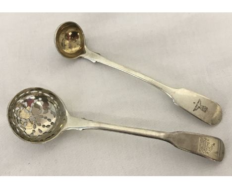 A Georgian silver sugar sifter spoon, hallmarked Solomon Hougham 1815. Crest to handle. Together with a Victorian salt spoon 