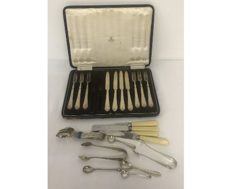 A collection of silver plated cutlery to include a pair of sugar nips by Daniel &amp; Arter. And a part set of fruit knives a