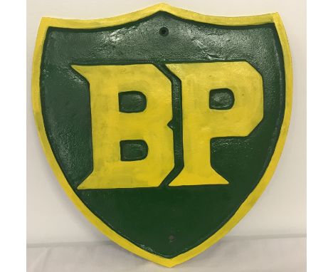 A large green and yellow painted cast iron BP wall hanging plaque.  Approx. 34cm x 31cm.