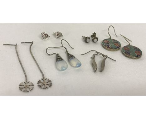 6 pairs of silver and white metal earrings in drop and stud styles. To include a pair of moonstone drops and opal set studs. 