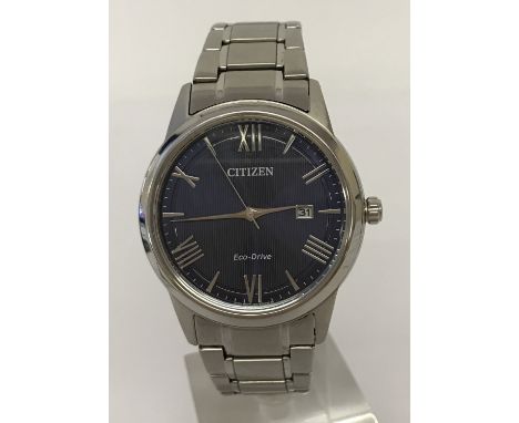A men's Citizen Eco-Drive wristwatch with blue face and stainless steel bracelet strap. Silver tone hands and hour markers wi