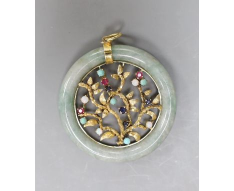 A 14k yellow metal and multi gem set circular jade pendant, diameter 51mm, gross weight 28.8 grams.