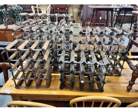 Four vintage wine racks, two labelled Farrow &amp; Jackson Ltd., London and Cumbria, total capacity 120 bottles, largest widt