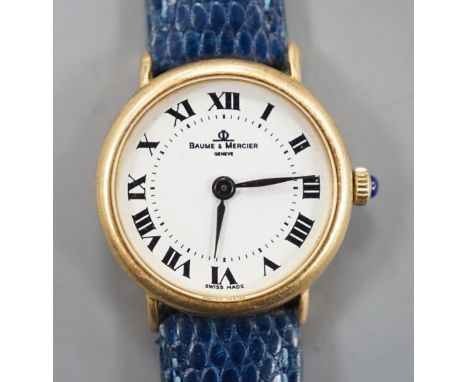 A lady's modern 18k Baume &amp; Mercier manual wind wrist watch, with Roman dial, on associated leather strap, case diameter 