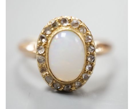 A yellow metal, white opal and rose cut diamond chip set oval ring, size O, gross weight 3 grams.