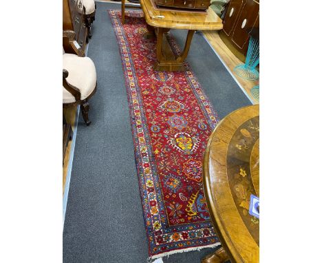 A North West Persian red ground runner, 426 x 100cm