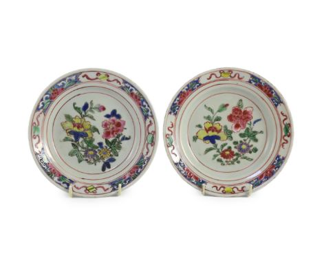 A pair of Chinese famille rose fencai small plates, early Yongzheng period,16 cms diameter, each painted with flowers to the 