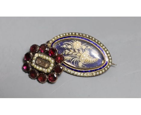 A Victorian yellow metal, garnet and seed pearl set mourning brooch, with plaited hair below a glazed panel, 24mm and a simil