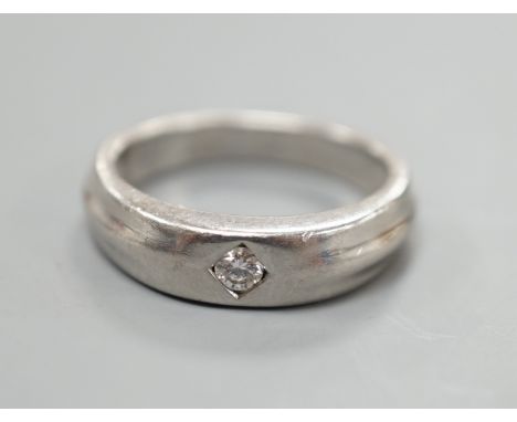 A modern platinum and gypsy set solitaire diamond ring, size K, 6.6 grams.