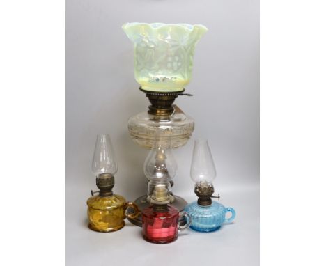 A Victorian oil lamp with vaseline glass shade and three small oil lamps,large oil lamp 49 cms high,
