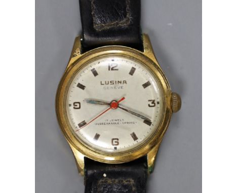 A steel and gold plated boy's size Lusina manual wind wrist watch, on leather strap.