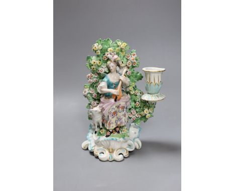 A Derby bocage candlestick, c.1770, modelled as a lady playing a lute,19cms high,