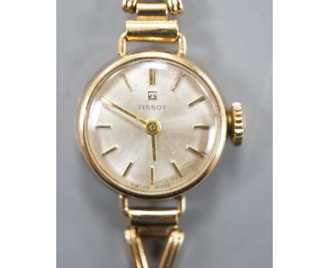 A lady's 9ct gold Tissot manual wind wrist watch, on a 9ct gold bracelet, overall length 16.25cm, gross weight 11.2 grams.