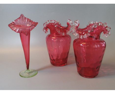 Three items of Victorian cranberry glass to include; pair of vases and an epergne vase. (3)(B.P. 21% + VAT) 