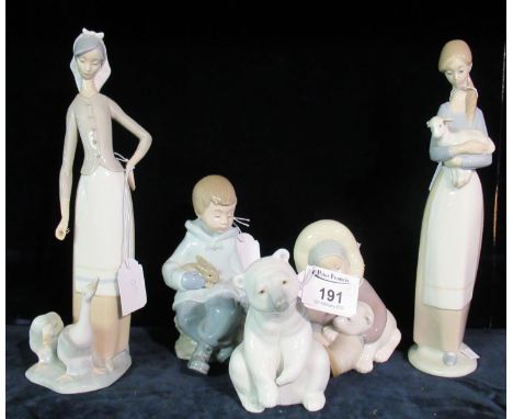 A collection of Lladro and Nao Spanish porcelain items to include; seated polar bear, Inuit with polar bear, figures with ani