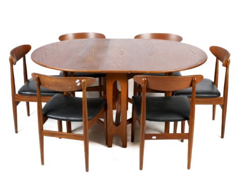 A Mcintosh mid-century oval gate leg table and a set of six chairs. H75cm x W154cm x D107.5cm (open)