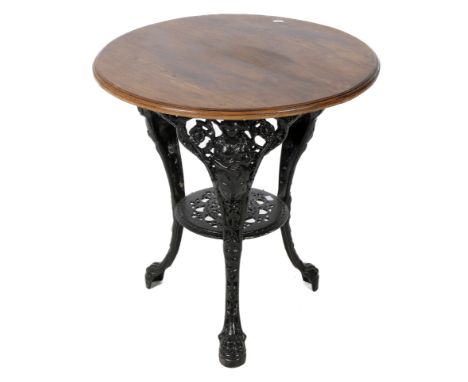 A 20th century 'pub' table. The circular oak top having a moulded edge, mounted on a cast metal base painted black, each of t