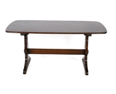A 1970s rectangular dark Ercol dining table. WIth gold and turquoise label, table H71cm x W150cm x D75cm. 