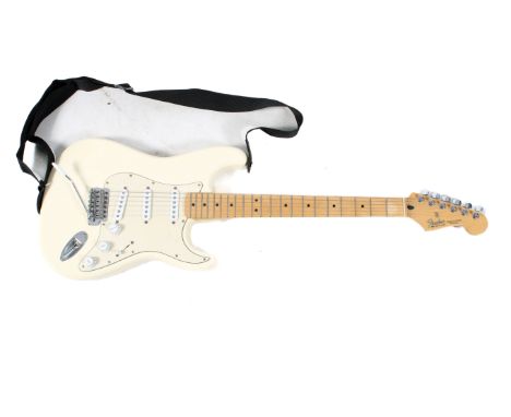 A Fender Stratocaster electric guitar in cream and canvas bag. S/n. MZ6152878.  Condition Report: Appears to be in a very goo