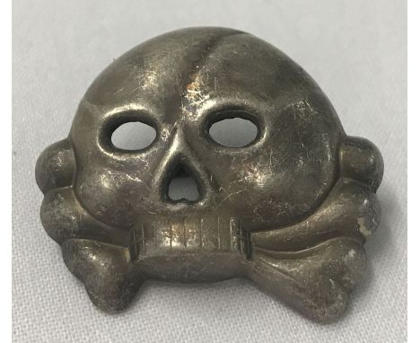 A WWII style Waffen SS Allgemeine Totenkopf cap skull badge. With 2 slider fixings. 