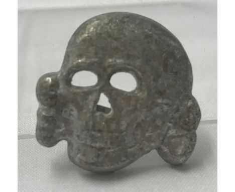 A German WWII style Waffen SS Totenkopf visor skull badge.  