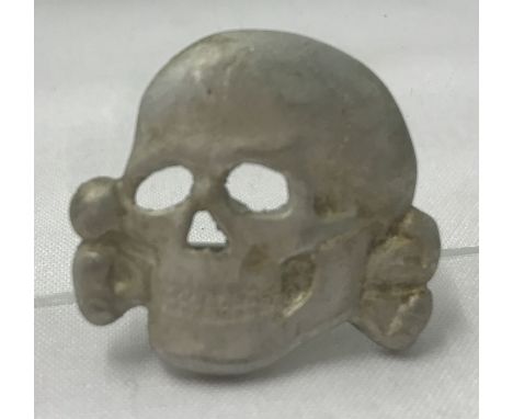 A German WWII style Waffen SS Totenkopf visor skull badge.  